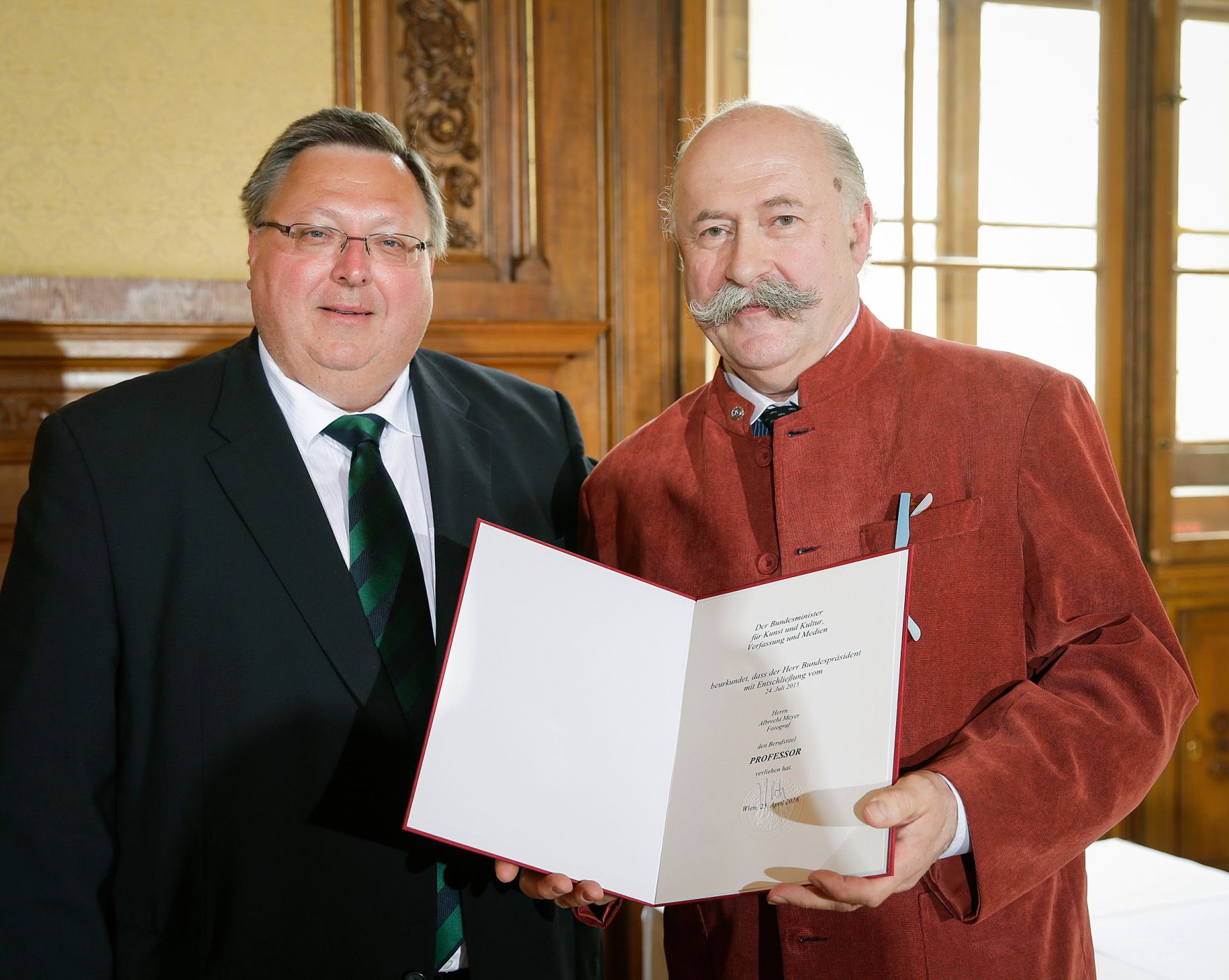Am 25. April 2016 &uuml;berreichte Ministerialrat Reinhold Hohengartner (l.) die Urkunde, mit der Albrecht Meyer (r.) der Berufstitel Professor verliehen wurde.