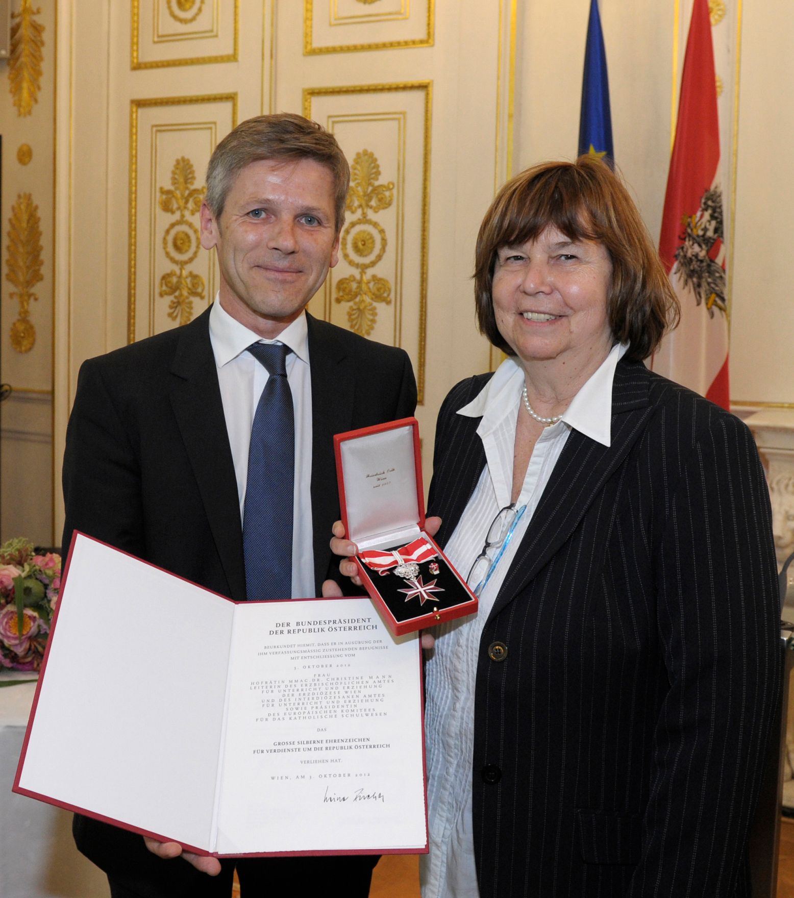 Am 25. Juni 2013 &uuml;berreichte Staatssekret&auml;r Josef Ostermayer (l.) das Gro&szlig;e Silberne Ehrenzeichen f&uuml;r Verdienste um die Republik &Ouml;sterreich an Christine Mann (r.), Leiterin des Erzbisch&ouml;flichen Amtes f&uuml;r Unterricht und Erziehung der Erzdi&ouml;zese Wien.