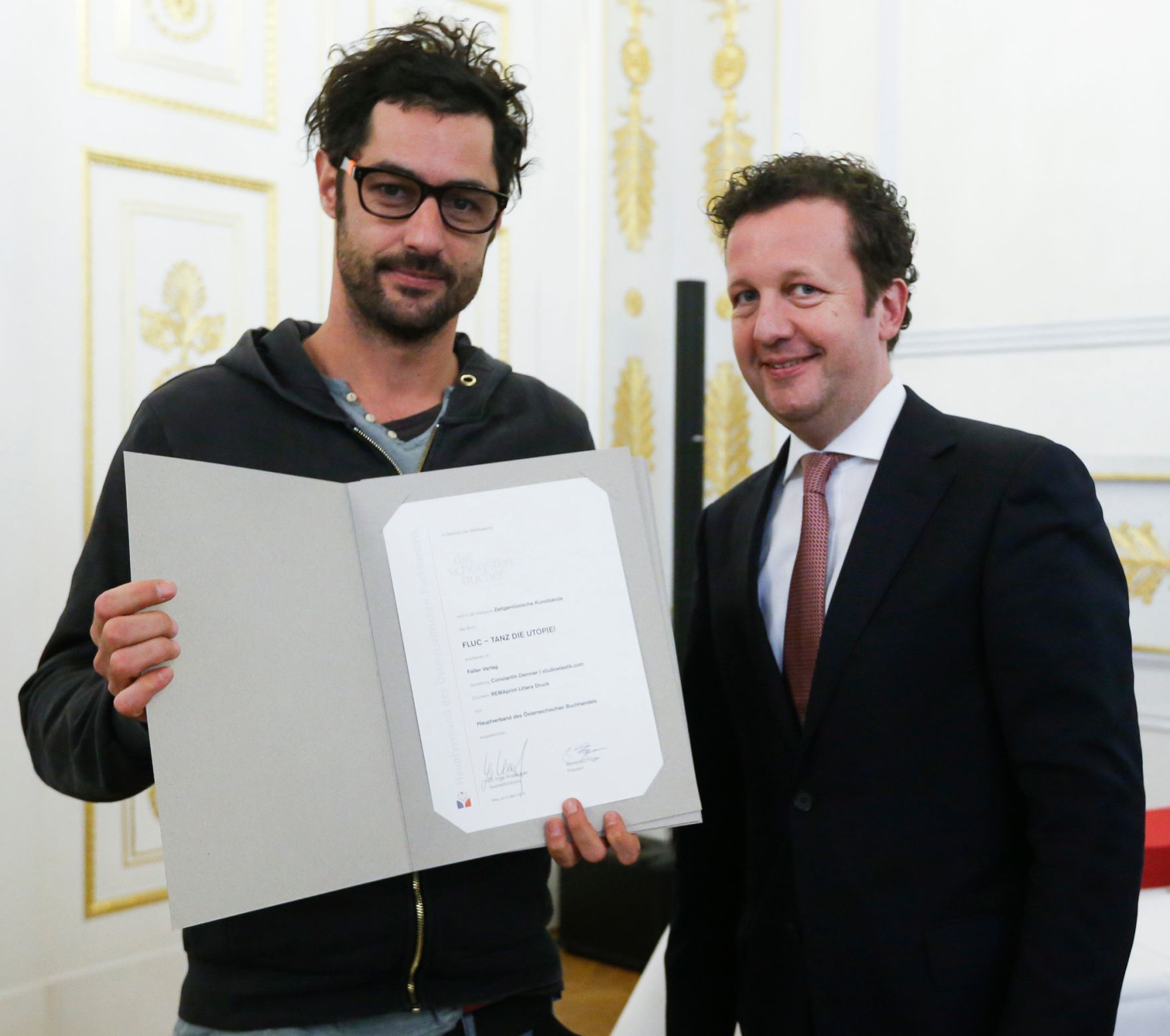 Am 4. M&auml;rz 2015 fand im Bundeskanzleramt die Staatspreisverleihung f&uuml;r die 'sch&ouml;nsten b&uuml;cher &ouml;sterreichs' statt. Im Bild der Pr&auml;sident des Hauptverbandes des &Ouml;sterreichischen Buchhandels, Benedikt F&ouml;ger (r.) mit dem Preistr&auml;ger Constantin Demner (l.).