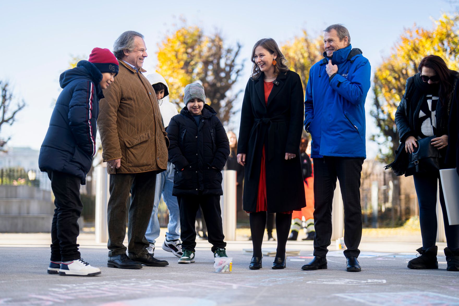 Am 19. November 2025 besuchte Bundesministerin Claudia Plakolm (3.v.r.) die Stra&szlig;enkreide-Malaktion zum Tag der Kinderrechte vor dem Bundeskanzleramt.