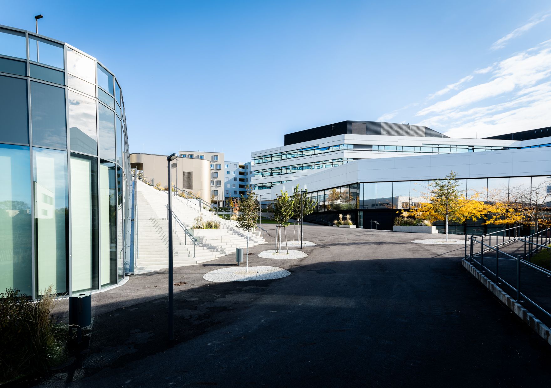 Hochschule Campus Wien au&szlig;en &ndash; Moderner Hochschulkomplex mit Glasfassade und weitl&auml;ufigem Vorplatz Hochschule Campus Wien, Fachhochschule Wien, Hochschule, Studium, Bildung, Forschung, Wissenschaft, Universit&auml;tsgeb&auml;ude, moderner Campus, Architektur, Glasfassade, Neubau, Bildungseinrichtung, Favoriten, 10. Bezirk Wien, Stadtentwicklung, Lifesciences, Technik, Gesundheitswesen, Soziales, modernes Wien, urbaner Raum, nachhaltige Architektur, Bildungscampus