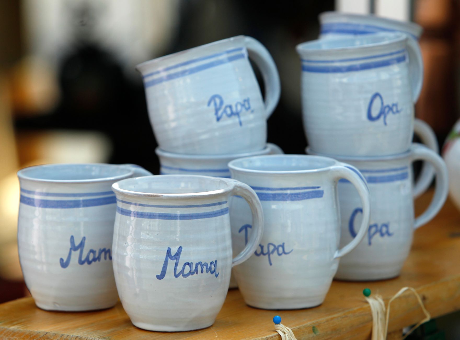 Bemalte Keramiktassen mit Beschriftung in blau-weiss. Schlagworte: Bauernmarkt, Beschriftung, Handwerk, H&auml;ferl, Mama, Markt, Marktst&auml;nde, Opa, Papa, Prozellan, Schild, Tassen, Wirtschaft