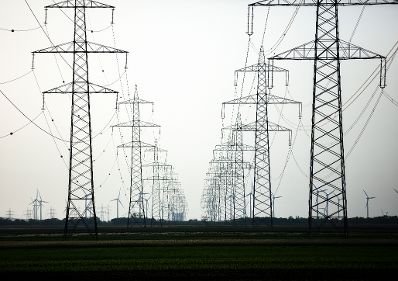 Windkraftanlagen in Betrieb, umgeben von Hochspannungsleitungen. Schlagw&ouml;rter: Windkraftanlagen, Wind, Energie, Technik, Strom, Nachhaltigkeit, Hochspannung, Rat f&uuml;r Verkehr, Telekommunikation und Energie, TTE
