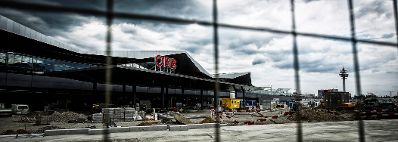 Die Baustelle des &Ouml;BB Hauptbahnhofes in Wien. Schlagworte: Baustelle, Geb&auml;ude, Gitter, Himmel, Wirtschaft, Wolken, Zaun
